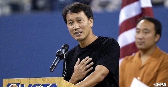 Michael Chang of the US speaks to the crowd with his brother and coach Carl Chang behind him