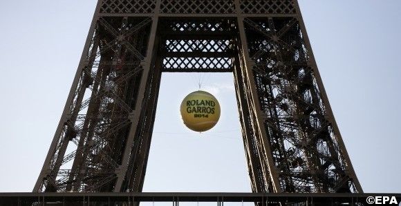 A giant tennis ball is placed inside the Eiffel tower in Paris